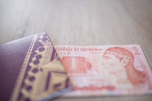 Swedish Passport and a One Honduran Lempira Bill on a Wooden Table