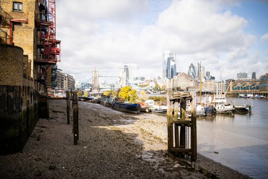 Landscape View of Docked Boats on River Thames with a Cityscape as Background