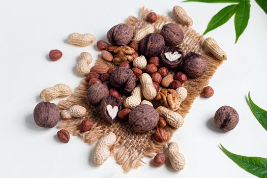 Almonds, walnuts, hazelnuts and peanuts, mix of nuts. Contains beneficial vitamins and minerals. On a gray background.