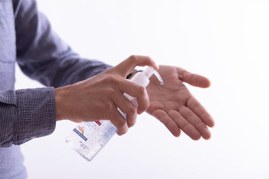 Man applying disinfectant alcohol gel on hands
