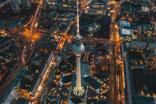 Berlin, Germany Alexanderplatz TV Tower after Sunset at Dusk with beautiful lit up Streets in orange lights of a Big City Cityscape, Aerial View circa September 2019