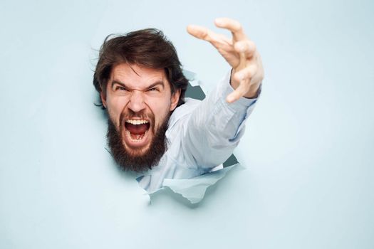 Angry man gestures with his hands dissatisfaction emotions work office