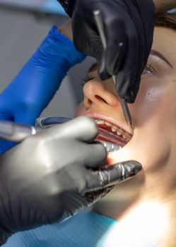 A woman at a dentist's appointment to replace arches with braces
