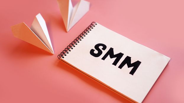 Social media marketing concept - SMM on a pink background