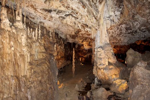 Cave with stalactites and stalagmites. Geological formation karst