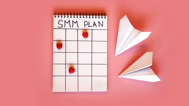 Social media marketing concept - SMM plan on a pink background