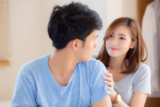 Young asian couple a problem and woman ask forgive and sorry wit