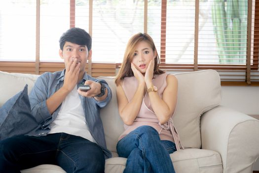 Young asian couple watching horror movie with relax and enjoy ho