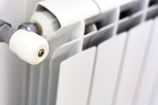 close-up view of the white knob that adjusts the temperature of the radiator