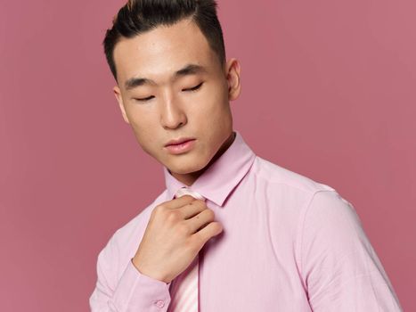 Man Asian appearance self confidence lifestyle pink background fashionable clothes