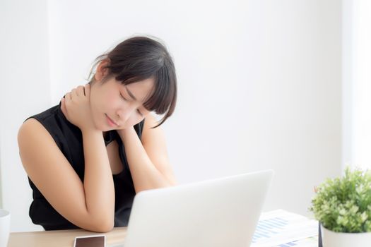 Business woman overwork on laptop computer and neck pain with at