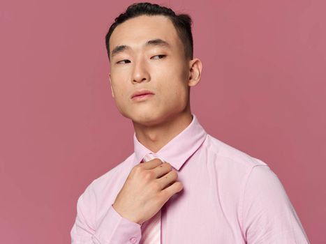 man asian appearance pink shirt self confidence cropped view isolated background
