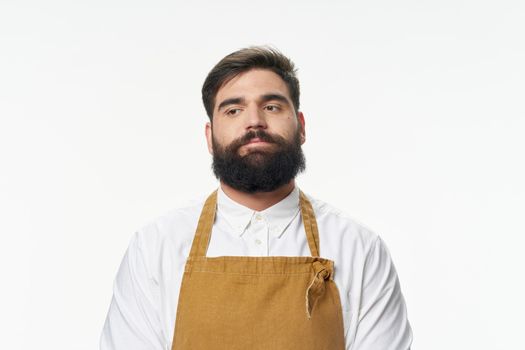 Bearded man in apron hairdresser professional barbershop