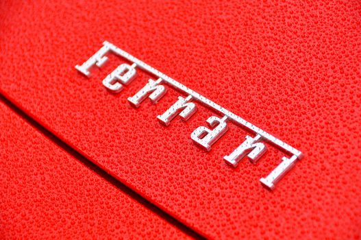 Ferrari sign on wet red bodywork
