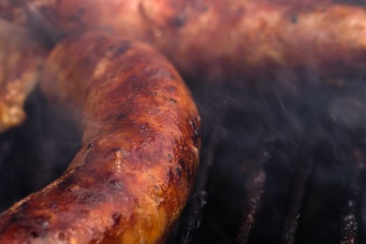 Close up on details of homemade sausages on barbecue grill. Barb