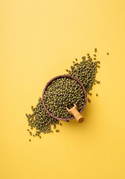 Mung beans top view on yellow background