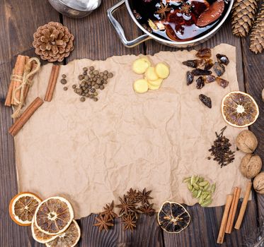 ingredients for making mulled wine on a wooden table and a piece