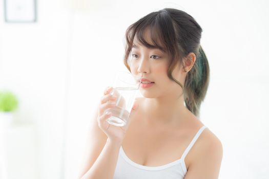 Beautiful portrait young asian woman caucasian smiling with nutrition thirsty and drinking glass of water mineral with fresh and happy, asia girl diet for healthy care and wellness, lifestyle concept.