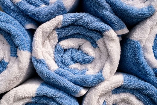 Rolled up of blue and white spa or pool towels.