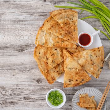 Taiwanese delicious scallion pancake over wooden table backgroun