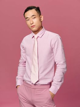 Elegant man asian appearance self confidence studio lifestyle pink background model