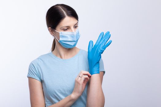 Nurse with face mask wear and checking protective gloves