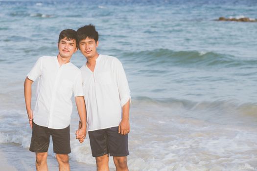 Homosexual portrait young asian couple standing together on beac