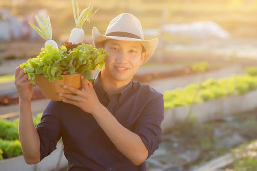 Portrait young asian man smiling harvest and picking up fresh or