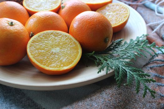 Lots of oranges and slices on a white plat