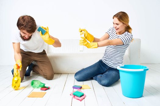 young couple washing floors working together on quarry detergent
