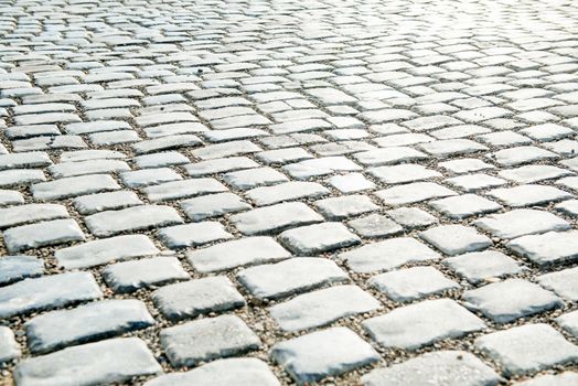 Road paved with cobble stones for your background