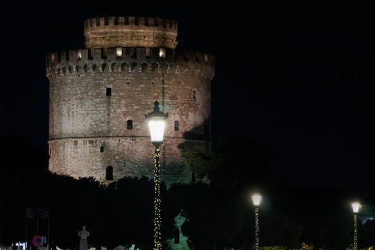 Thessaloniki Greece night view of The White Tower with Christmas lights decoration around.