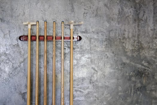 billiard cue sticks hang on wall