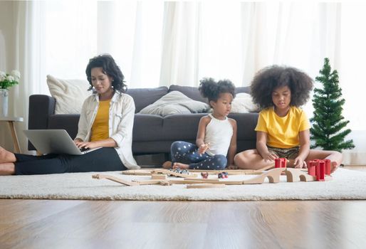 Mix race of family, dad, mom and daughters play together in living room
