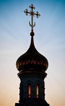 Beautiful silhouette of russian church dome against sunset sky
