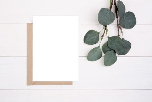 Blank paper sheet copy space with mockup and leaf on wooden table, card, poster and envelope, postcard decoration your design or branding, simplicity and minimal, nobody, flat lay, top view.