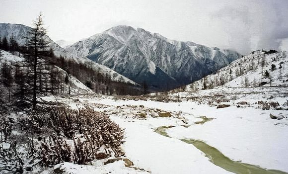Mount Sayan in winter in snow. The nature of the mountains is sayan.