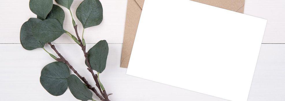 Blank paper sheet copy space with mockup and leaf on wooden table, card, poster and envelope, postcard decoration your design or branding, simplicity and minimal, flat lay, top view, banner website.