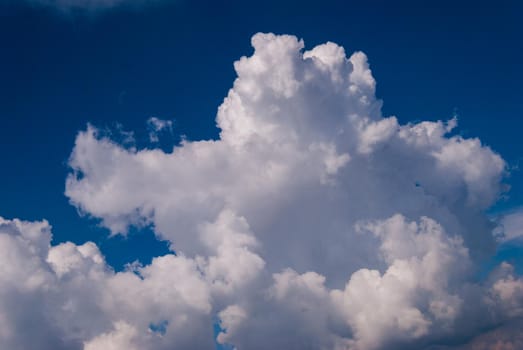 White cumulonimbus clouds on blue sky background