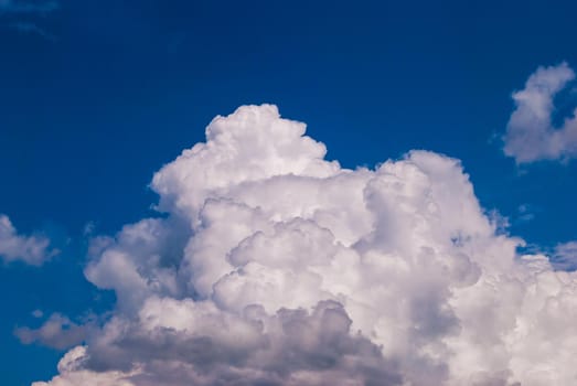 White cumulonimbus clouds on blue sky background