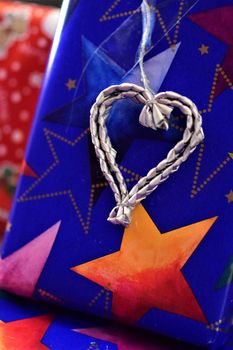 Close up of colorful christmas gifts with a silver colored heart