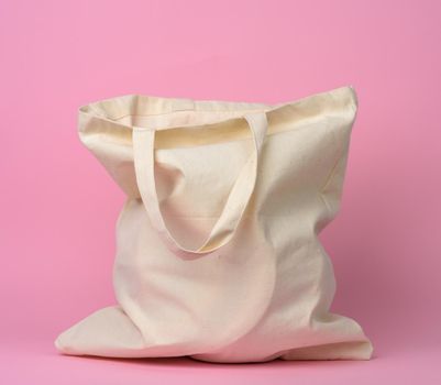 beige textile bag with on a pink background