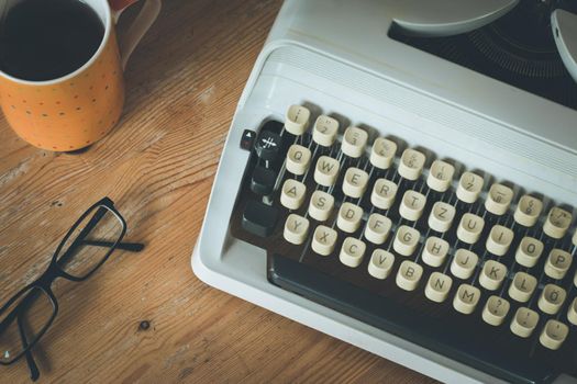 Old fashioned vintage typewriter on wood desk