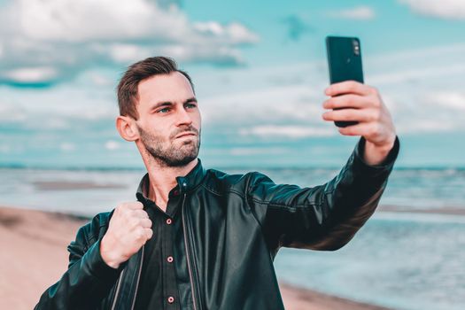 Handsome Youthful Guy Making Selfie at the Beach