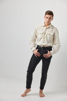 shirt holds hands in pockets posing fashion attractive look