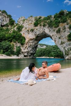couple on vacation in the Ardeche France , young men and woman visiting Narural arch in Vallon Pont D'arc in Ardeche canyon in France
