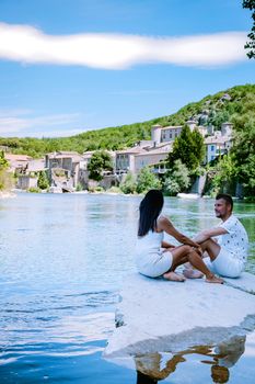 couple on vacation in Ardeche France, view of the village of Vogue in Ardeche. France