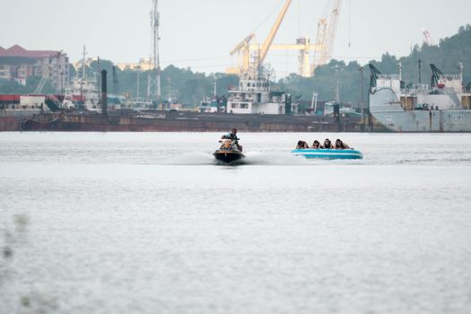 Beach water sports tubing with tourist being pulled by jetski in a beach in batam indonesia, Indonesia, May 4, 2019