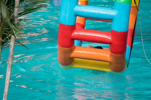 Swimming pool water sports large wheel tubing. Colorful water wheel tubing in a swimming pool