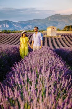 Couple men and woman on vacation at the provence lavender fields, Provence, Lavender field France, Valensole Plateau, colorful field of Lavender Valensole Plateau, Provence, Southern France. Lavender field